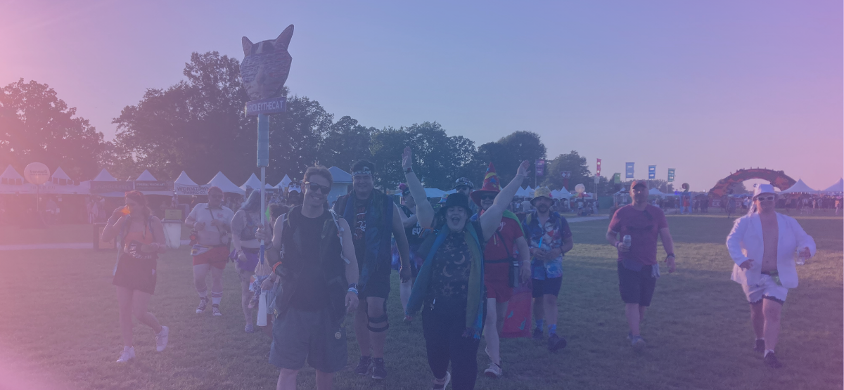 A group of friends walk through the What Stage field before the Pretty Lights performance during the 2024 Bonnaroo Music and Arts Festival.